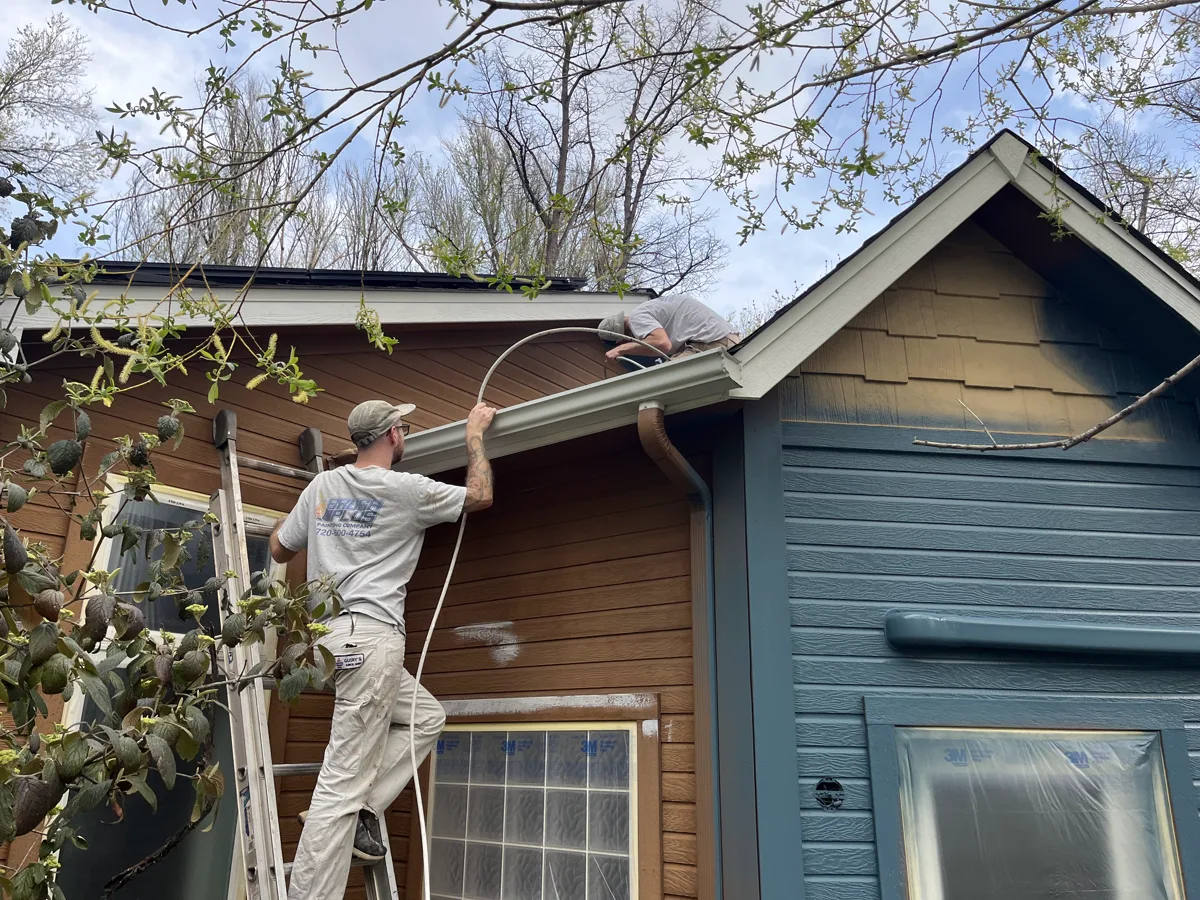 Brush Plus Painting crew working on exterior trim and gutters in Boulder County